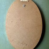 Old large oval wall mirror in golden resin