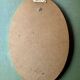 Old large oval wall mirror in golden resin
