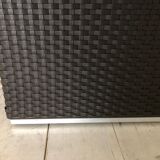 Pair of black synthetic rattan poufs from Flamant