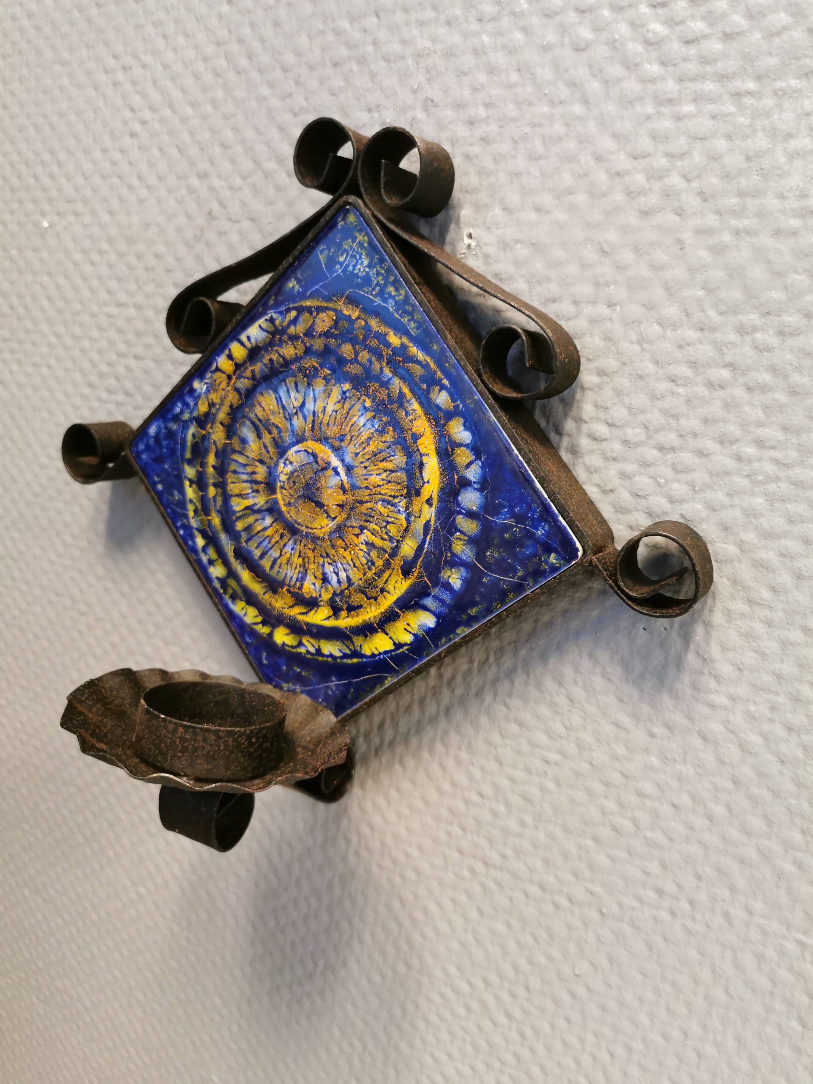 Wall-mounted candle holder in cast iron and ceramic. Estimated Danish and from the 70s.