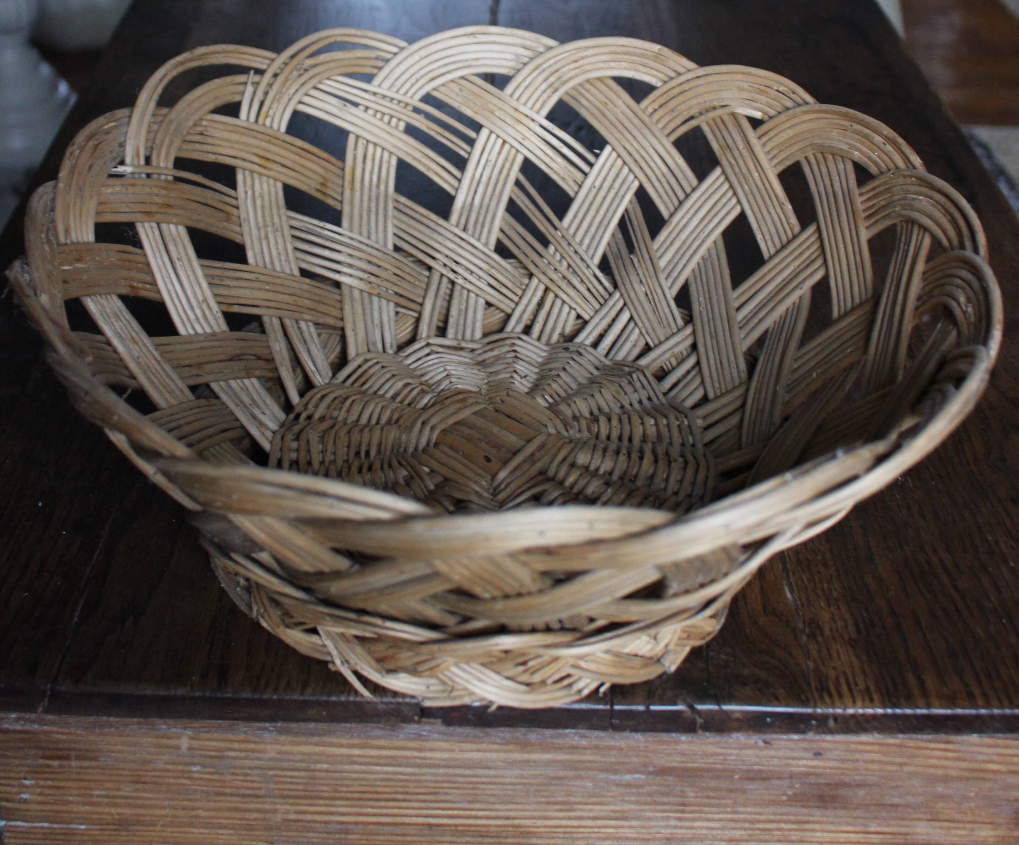 Large vintage twisted wicker basket on a stand