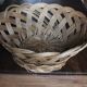 Large vintage twisted wicker basket on a stand