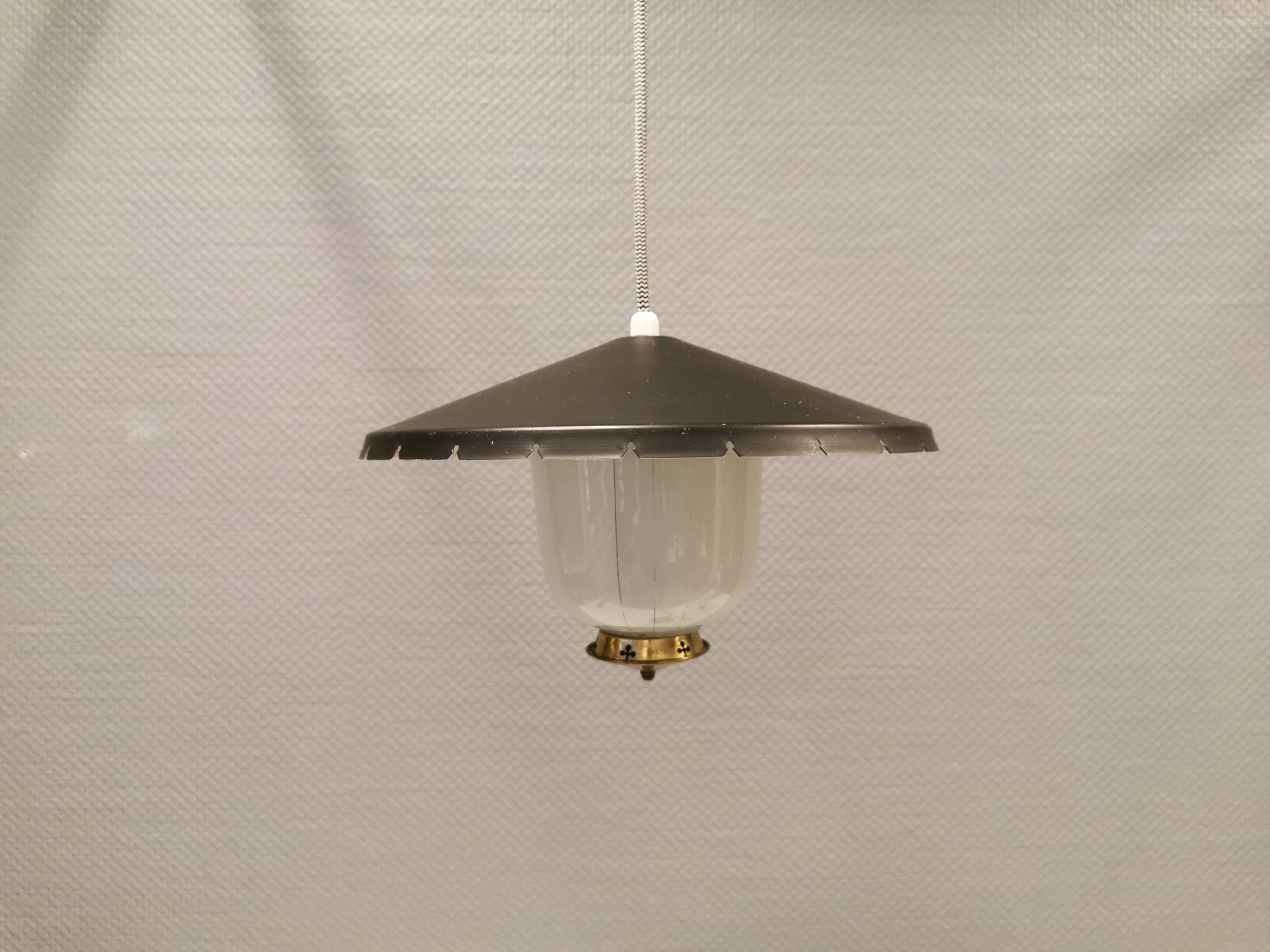 Hanging lamp in glass with black lacquered metal shade and brass base.