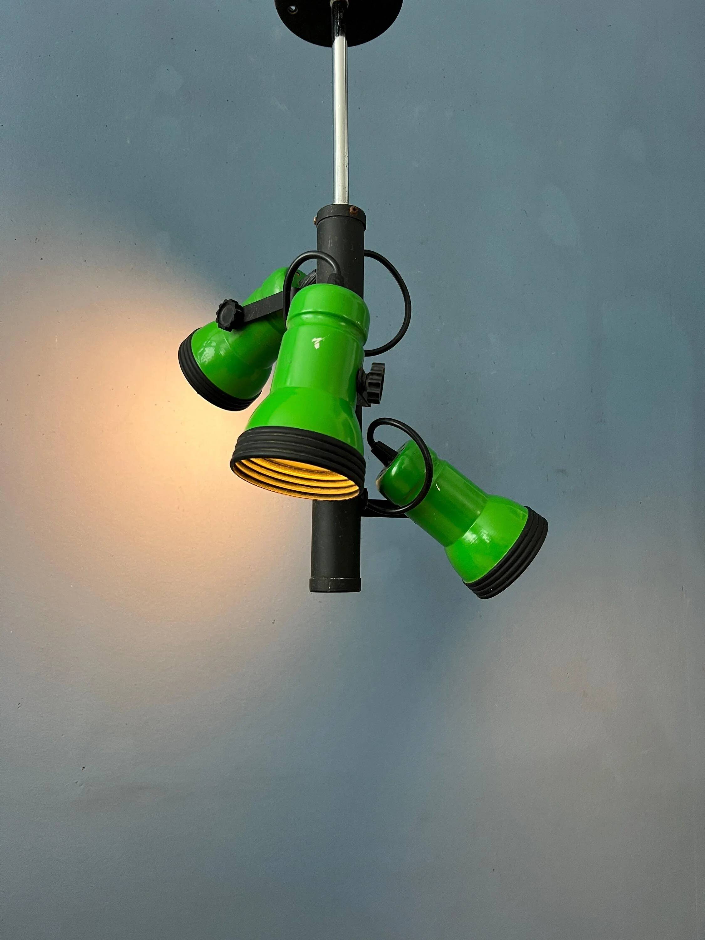 Vintage pendant light with three green spots.
