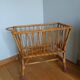 Rattan wicker cradle on wooden wheels