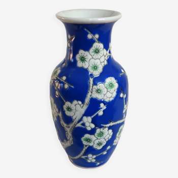 Old blue vase with vintage porcelain cherry blossoms