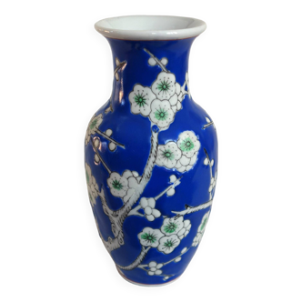 Old blue vase with vintage porcelain cherry blossoms