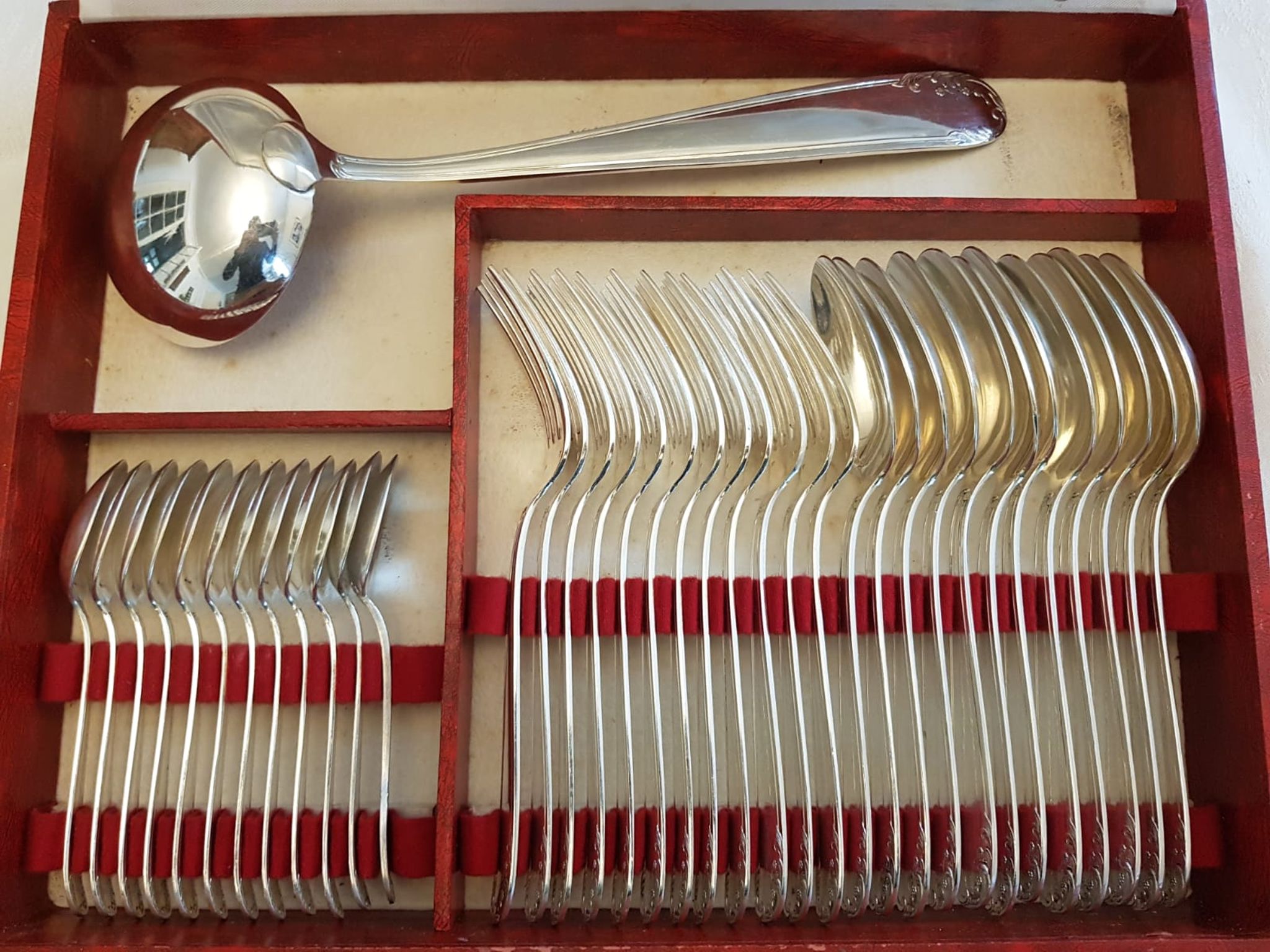 Silver cutlery set for 36 place settings and its ladle.