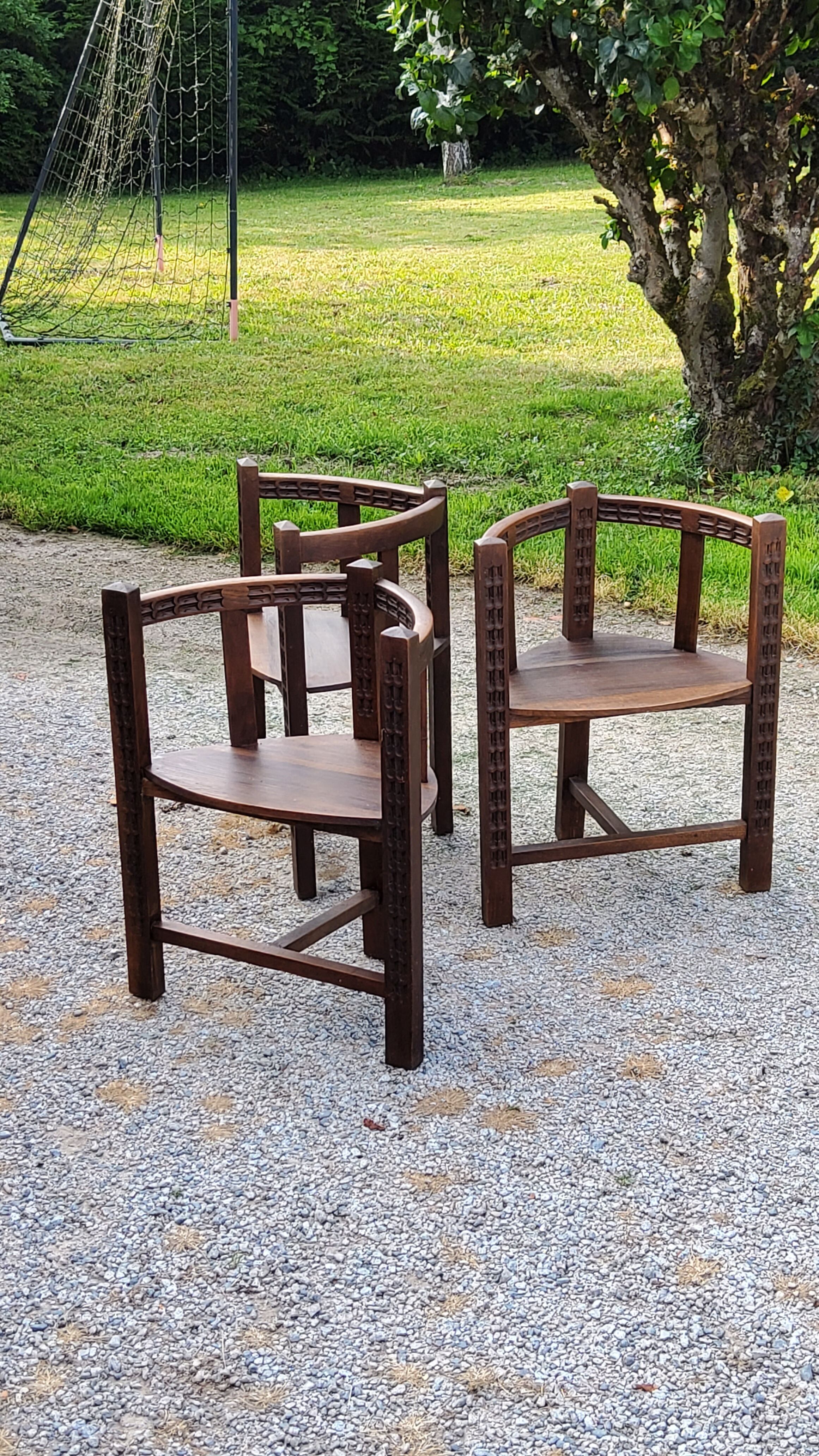 Set of three brutalist tripod armchairs in carved solid oak