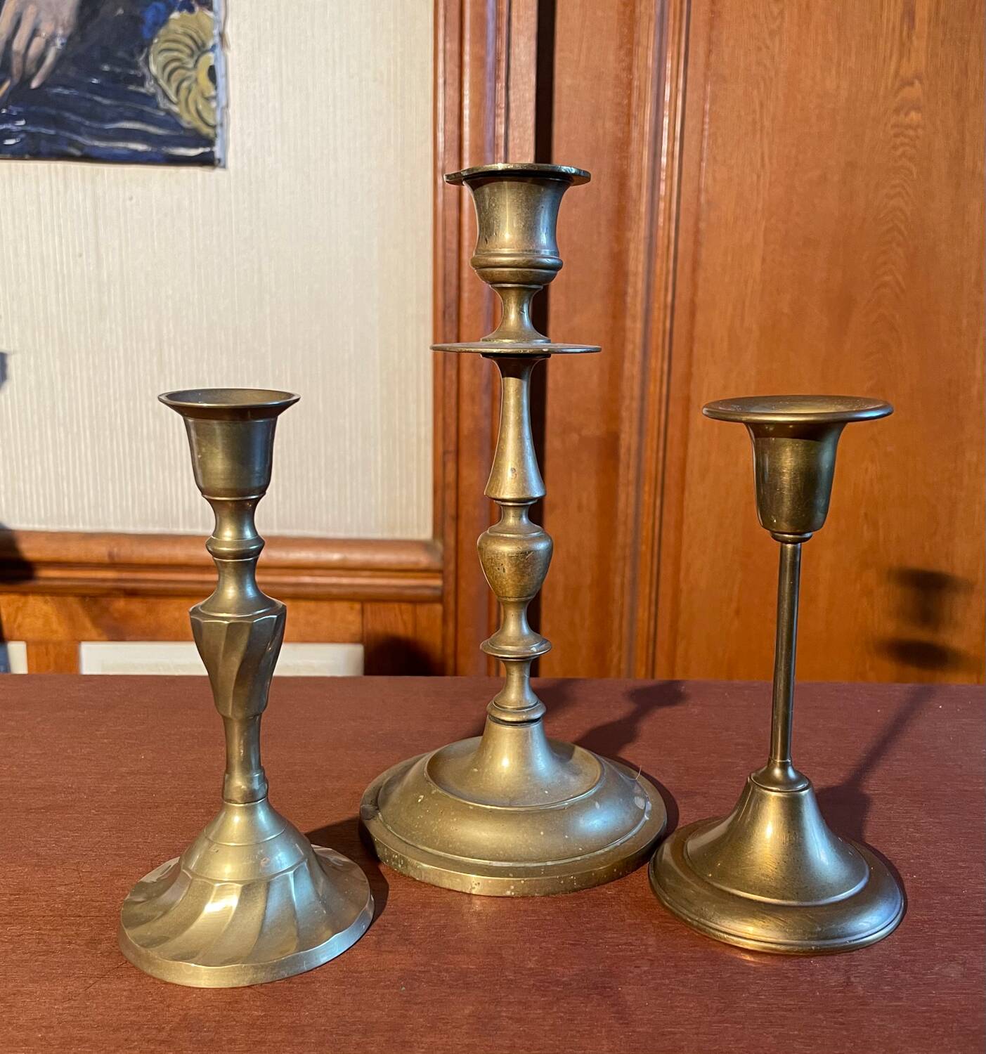 Trio of brass candlesticks
