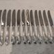12 silver-plated metal dessert knives with rocaille ribbon decoration, 21.4 cm