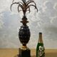 Large pineapple table lamp in carved black and gold wood, France, early 20th century.