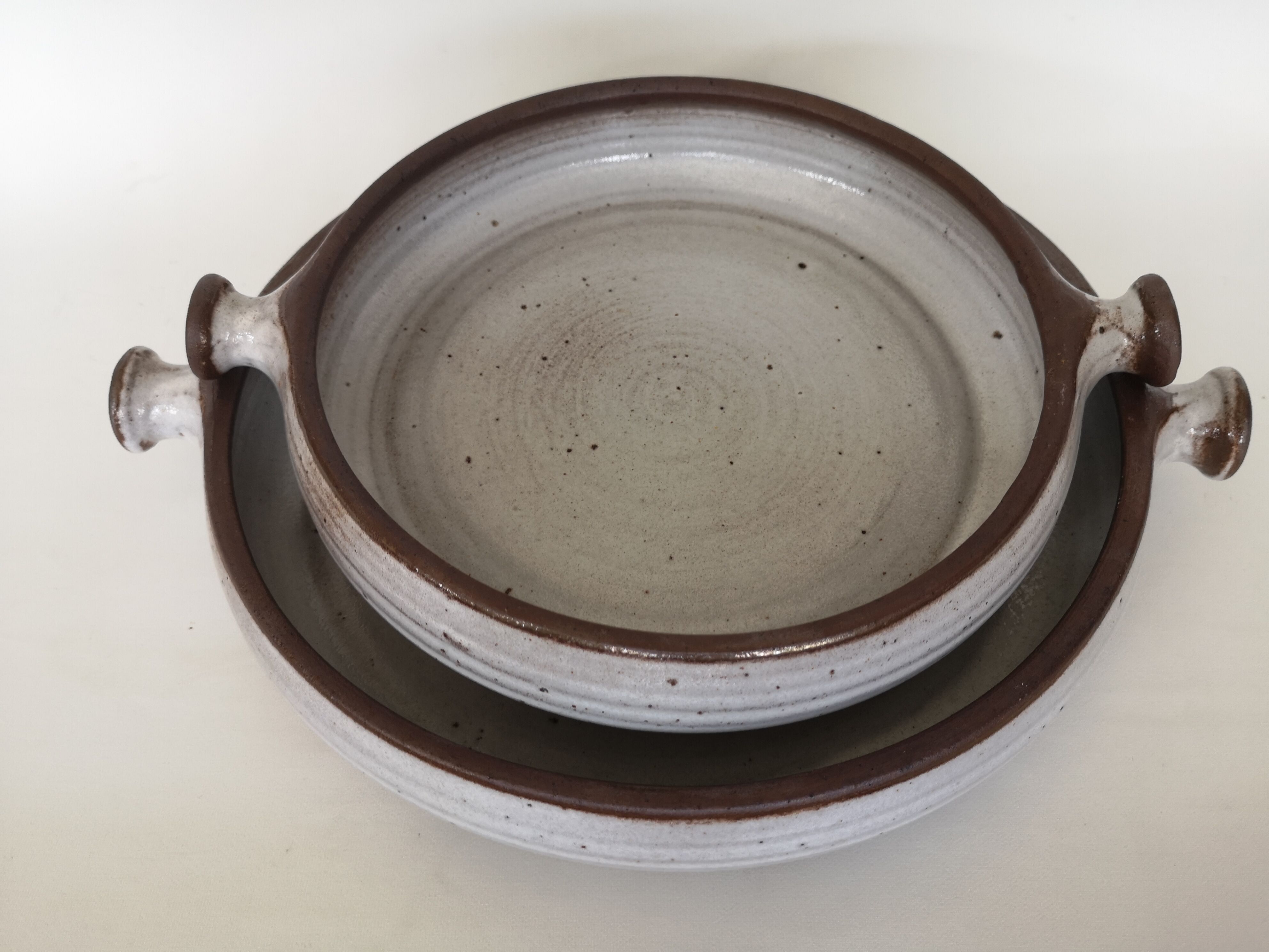Pair of enamelled sandstone dishes