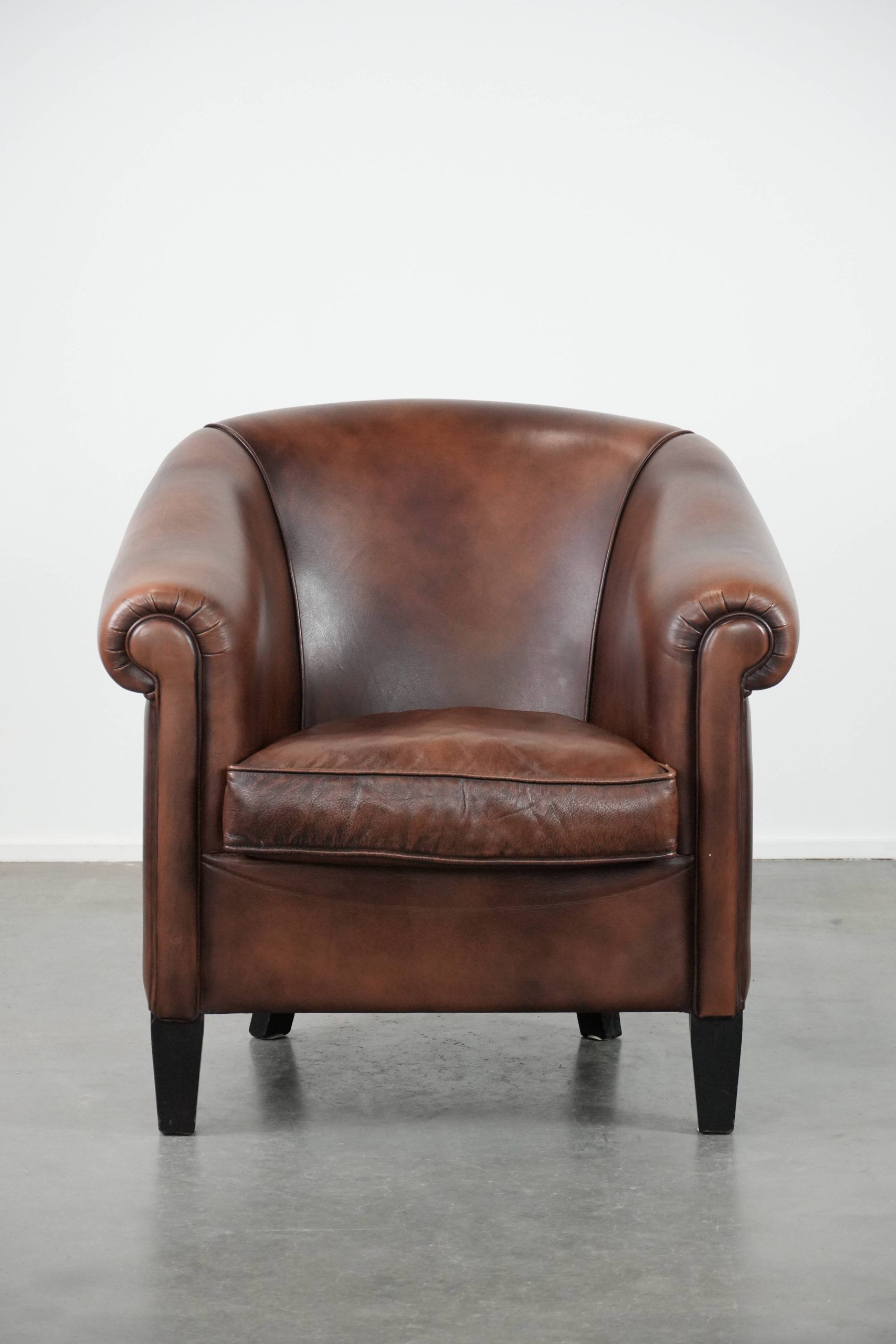 Great luxurious brown cowhide club armchair with matching piping