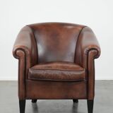 Great luxurious brown cowhide club armchair with matching piping