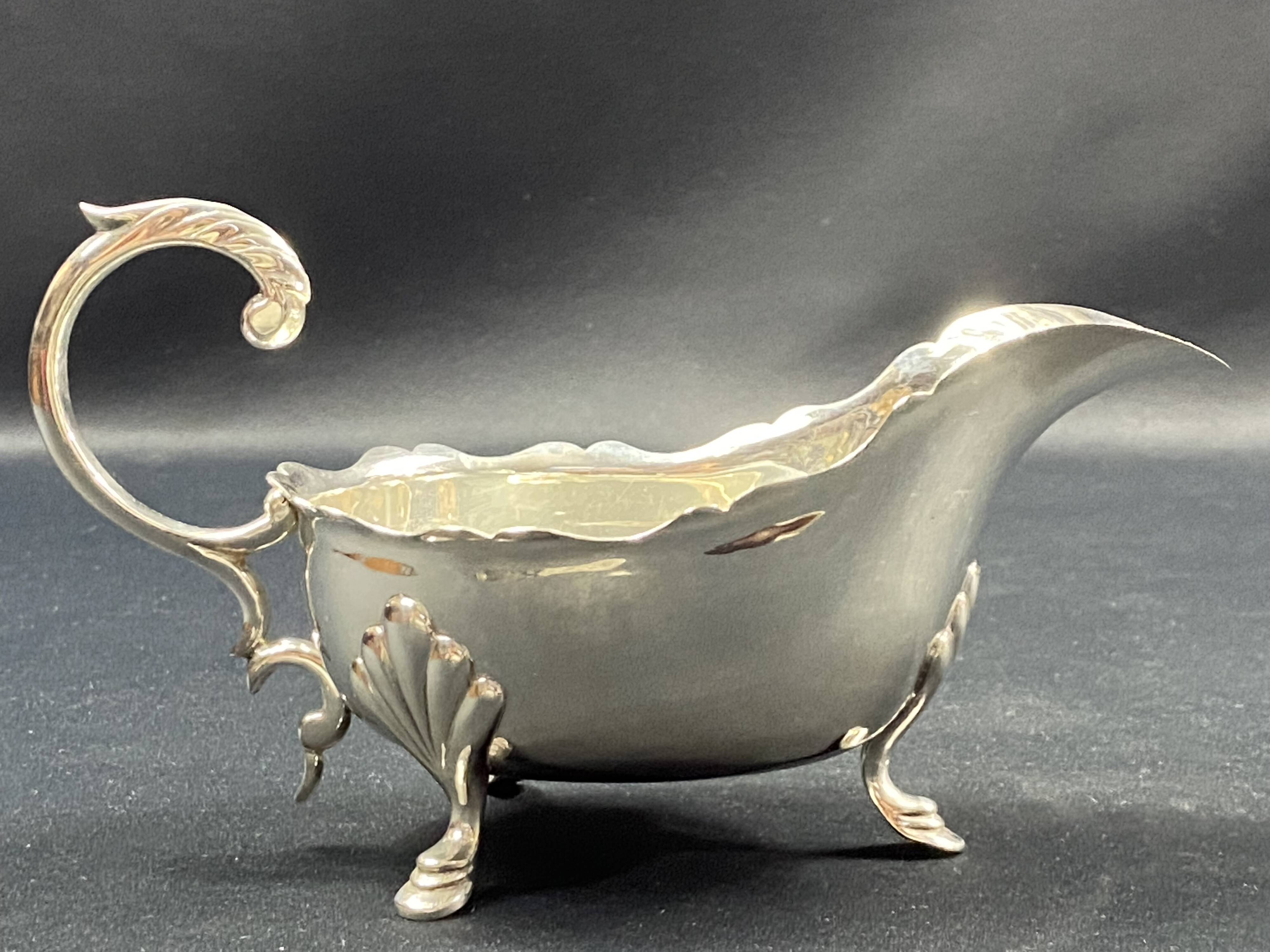 English George III style silver plated tripod sauce boat