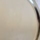 Vintage round metal plate with silver trim and beads.
