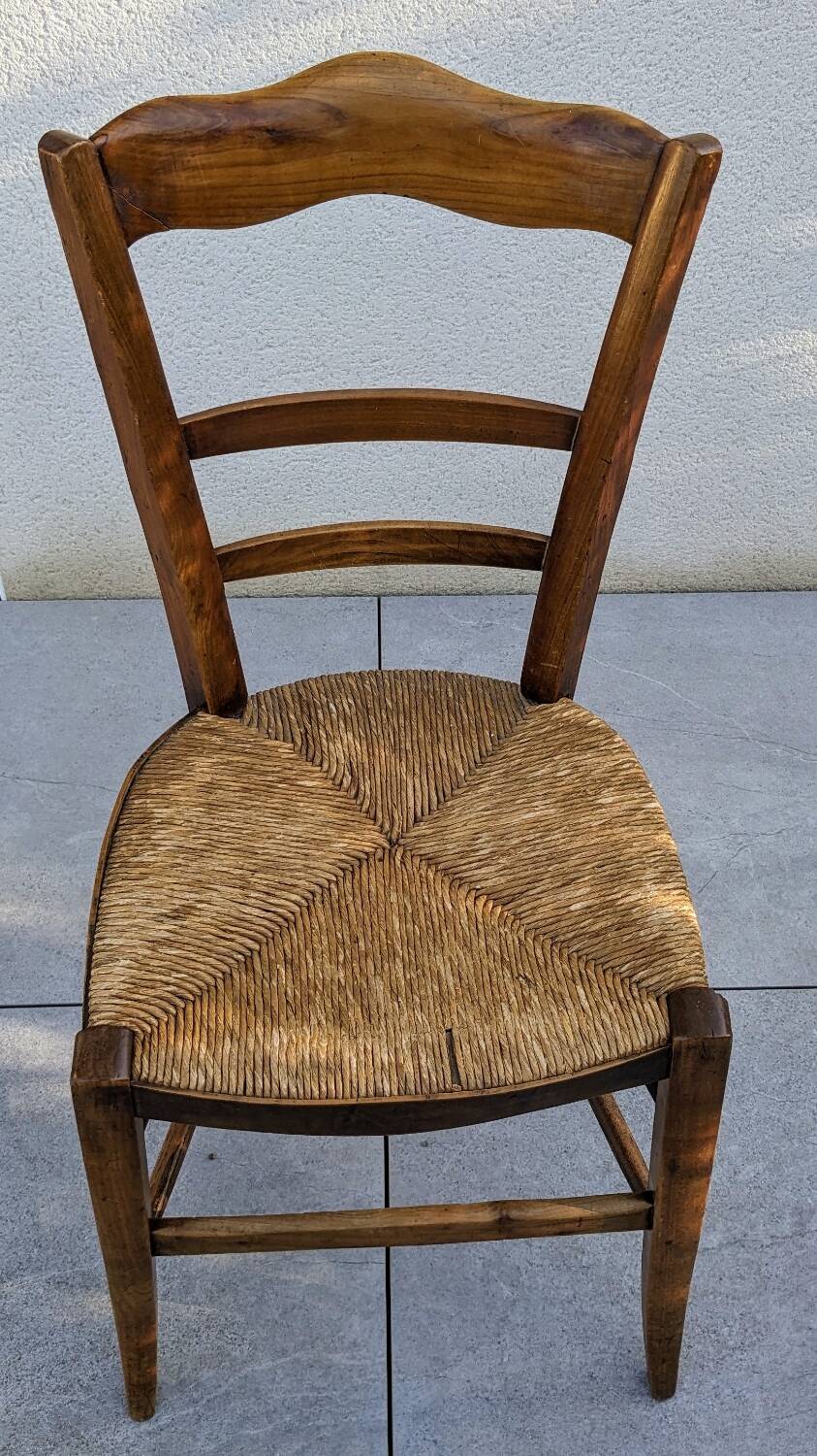 4 mismatched wood and straw chairs