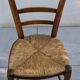 4 mismatched wood and straw chairs