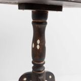 Vintage side table from the early 19th century, dark wood with mother-of-pearl inlays, oval shape with three legs, ethnic style.