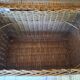 Wicker travel trunk XIX with metal clasps and handles.