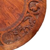 Circular tripod coffee table in carved wood