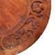 Circular tripod coffee table in carved wood
