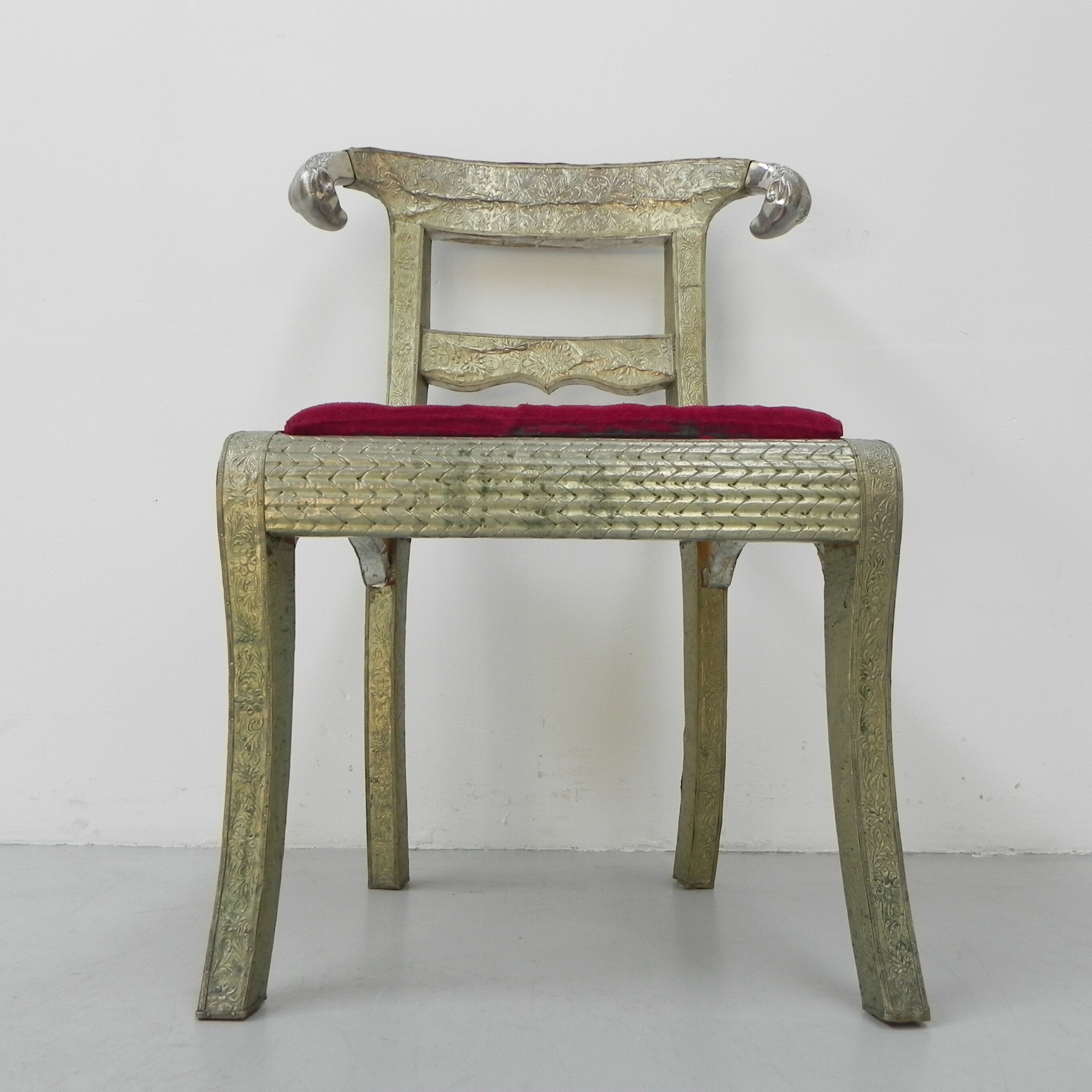 Dining chair upholstered with stamped tin