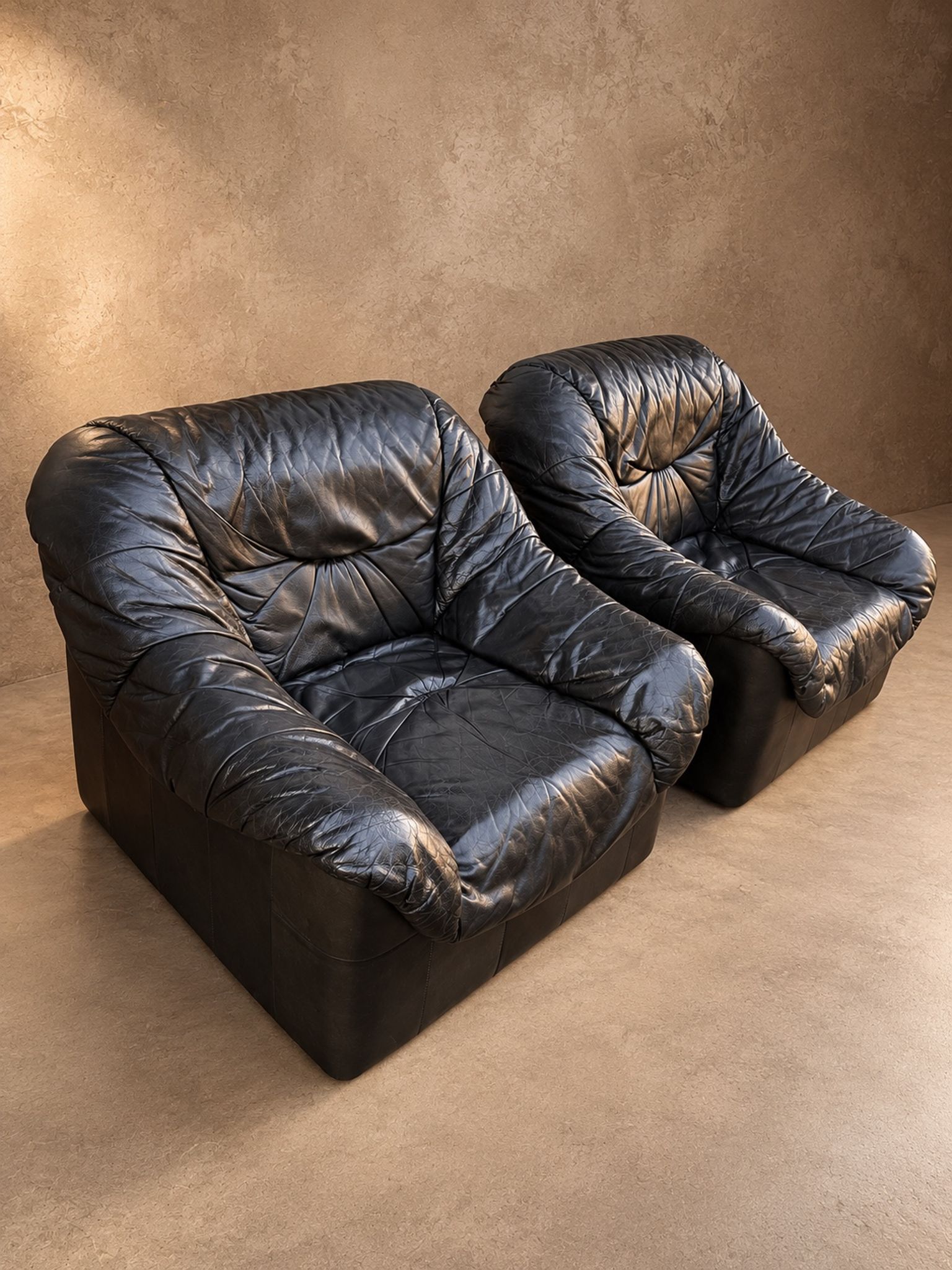 Leather armchairs and matching pouf, Italy, circa 1980