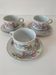 Trio of floral porcelain cups and saucers
