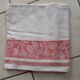White damask tablecloth. Breve. Large red entourage.