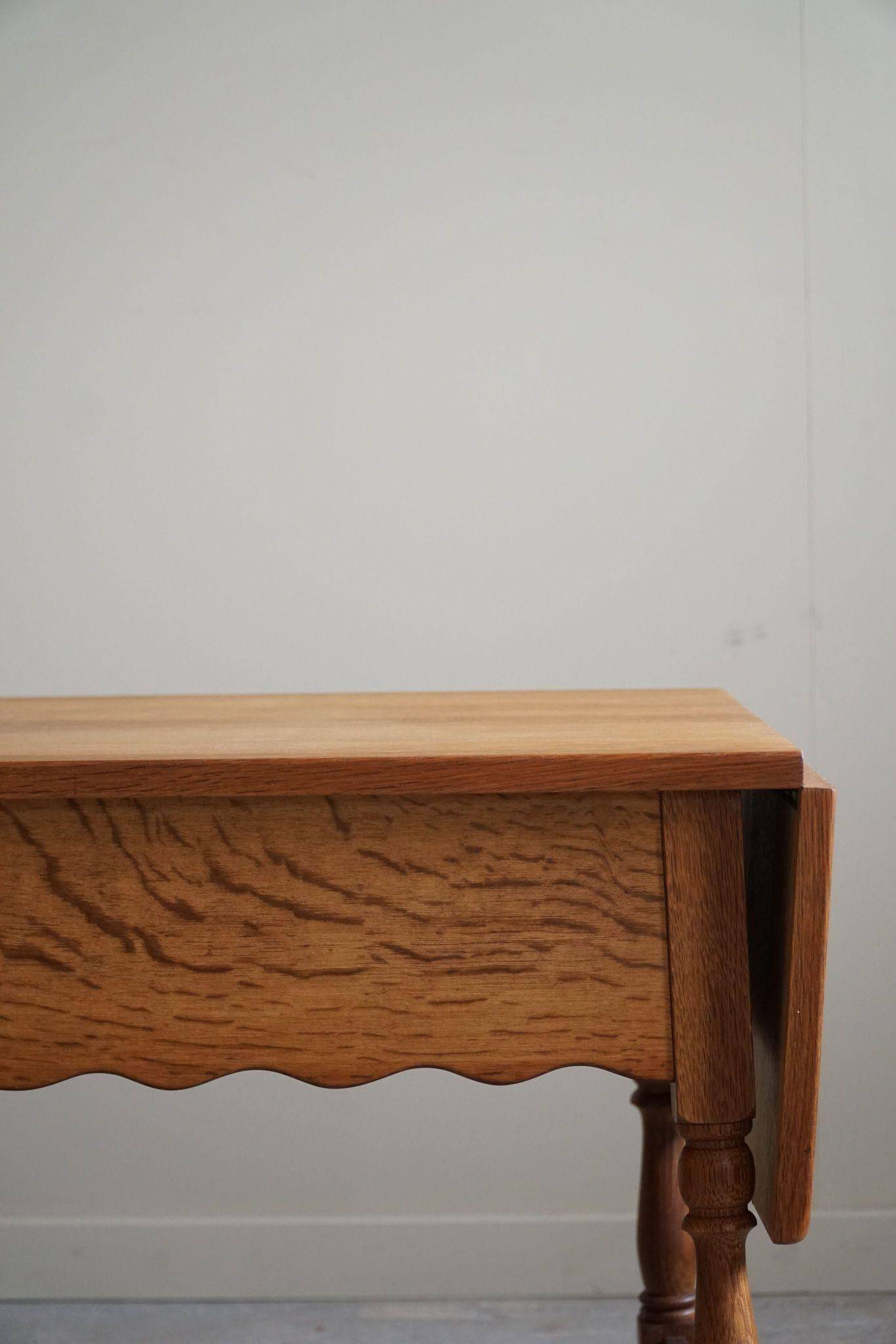 Danish folding table from the mid-century with a drawer in oak, Henning Kjærnulf, 1960s.