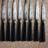 A set of 8 small knives with black wooden ferrules