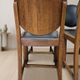 Set of four vintage wooden dining chairs with black leather upholstery