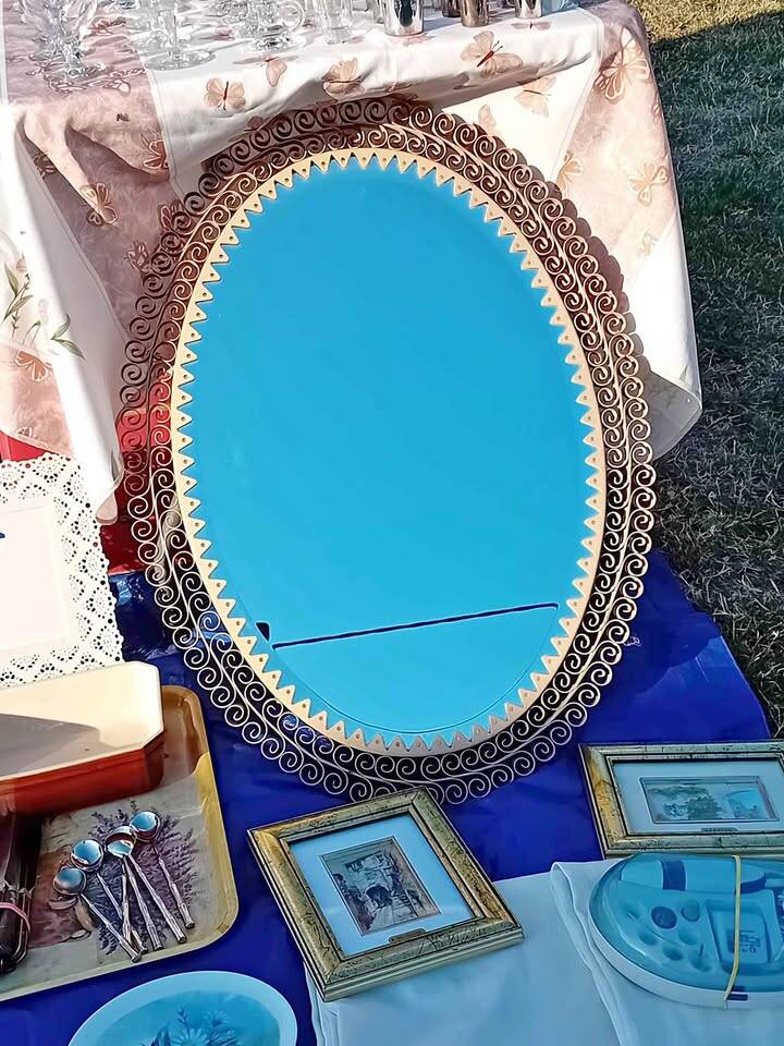 Engraved mirror surrounded by metal