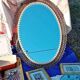 Engraved mirror surrounded by metal