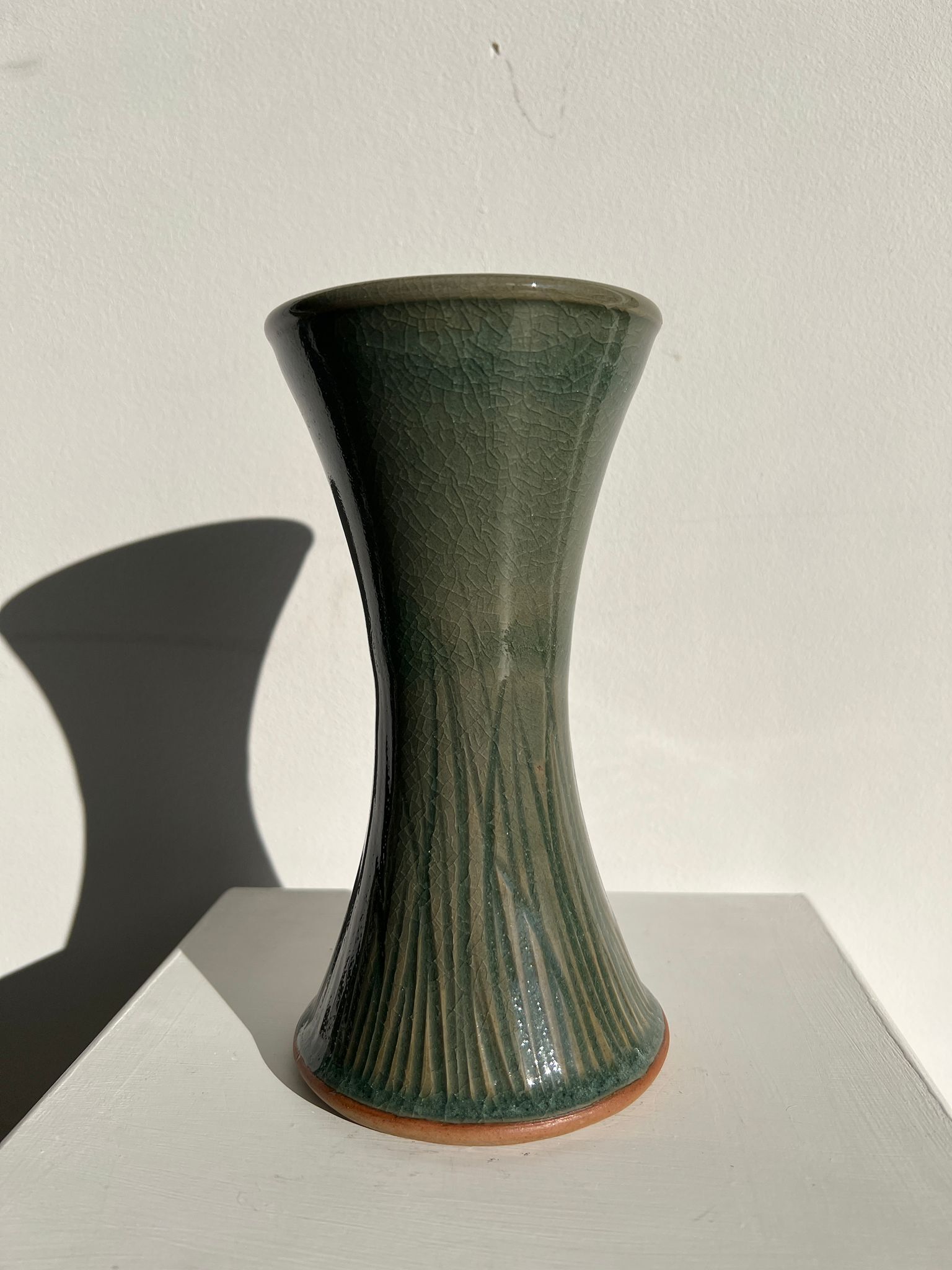 Dark green handcrafted vase with glazed ceramic grass blades
