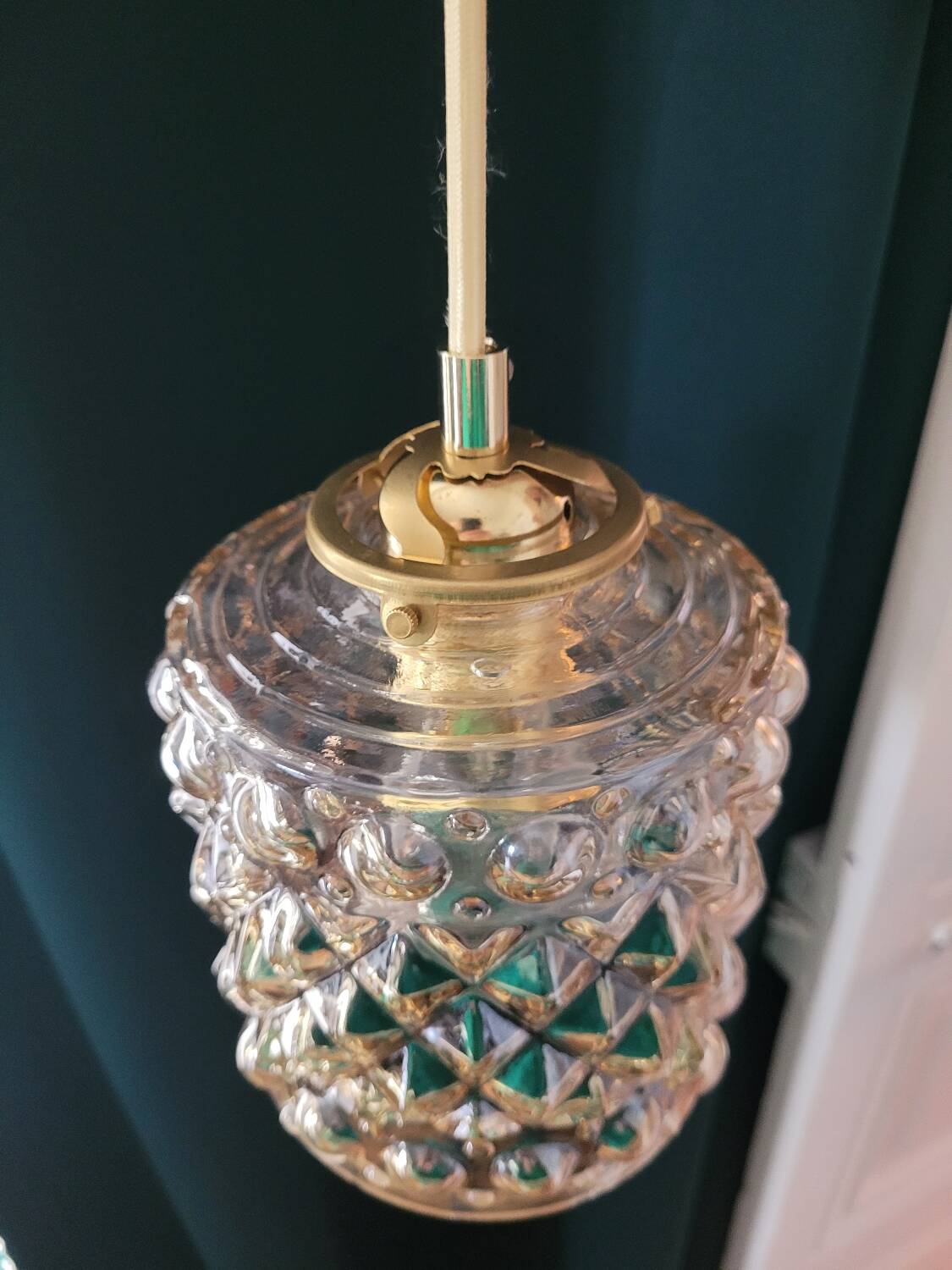 Moulded glass lamp with a cubic-spherical relief design.