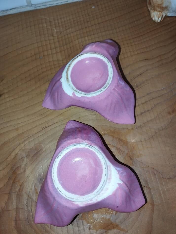 A pair of pink earthenware candlesticks (1940s–50s)