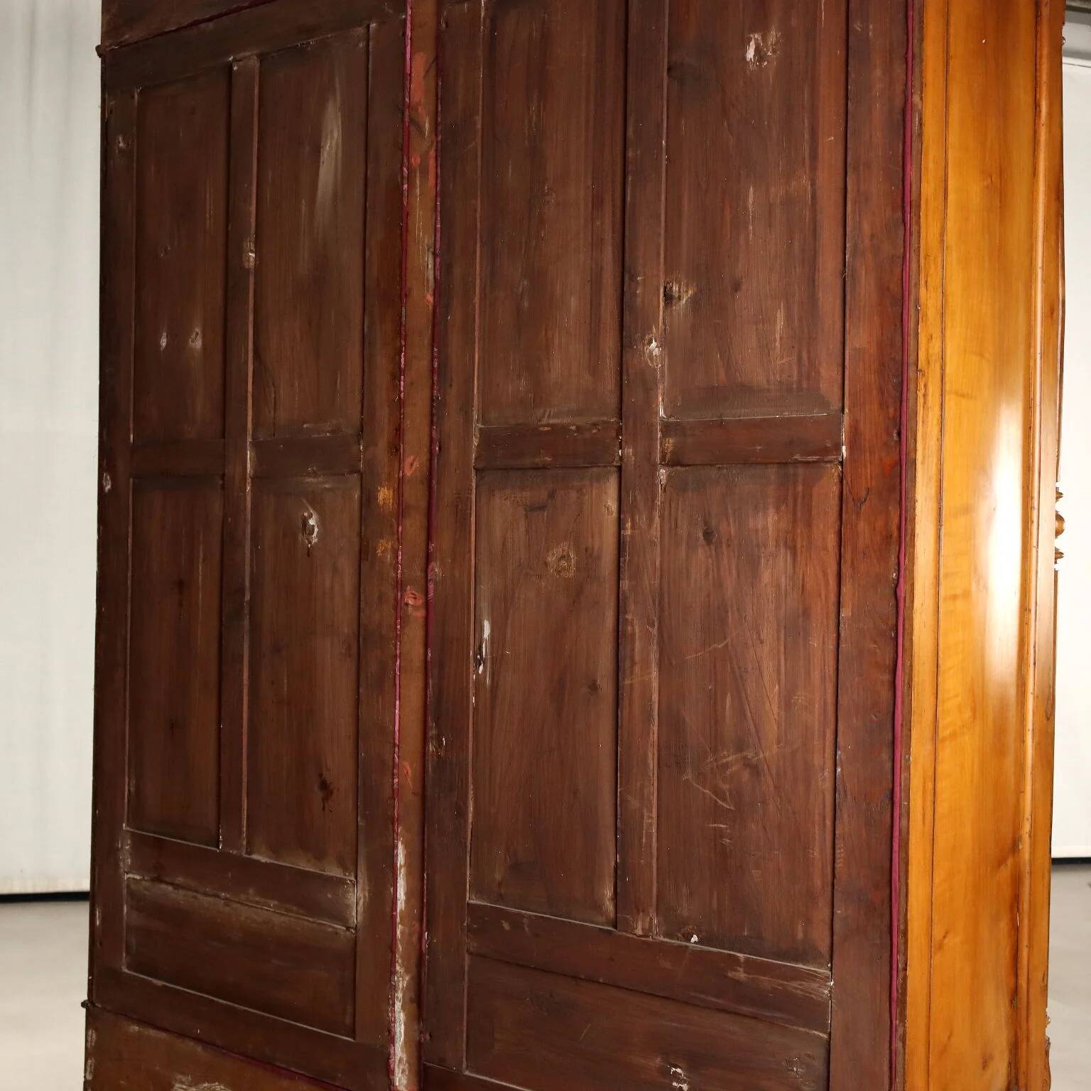 Antique walnut wardrobe with glass and carvings, Italy, 19th century.