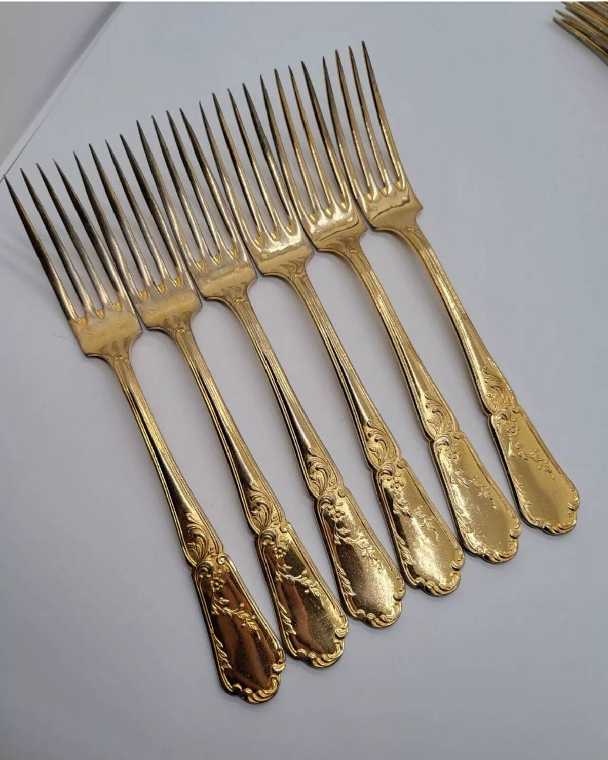 12 Table Forks in gold metal