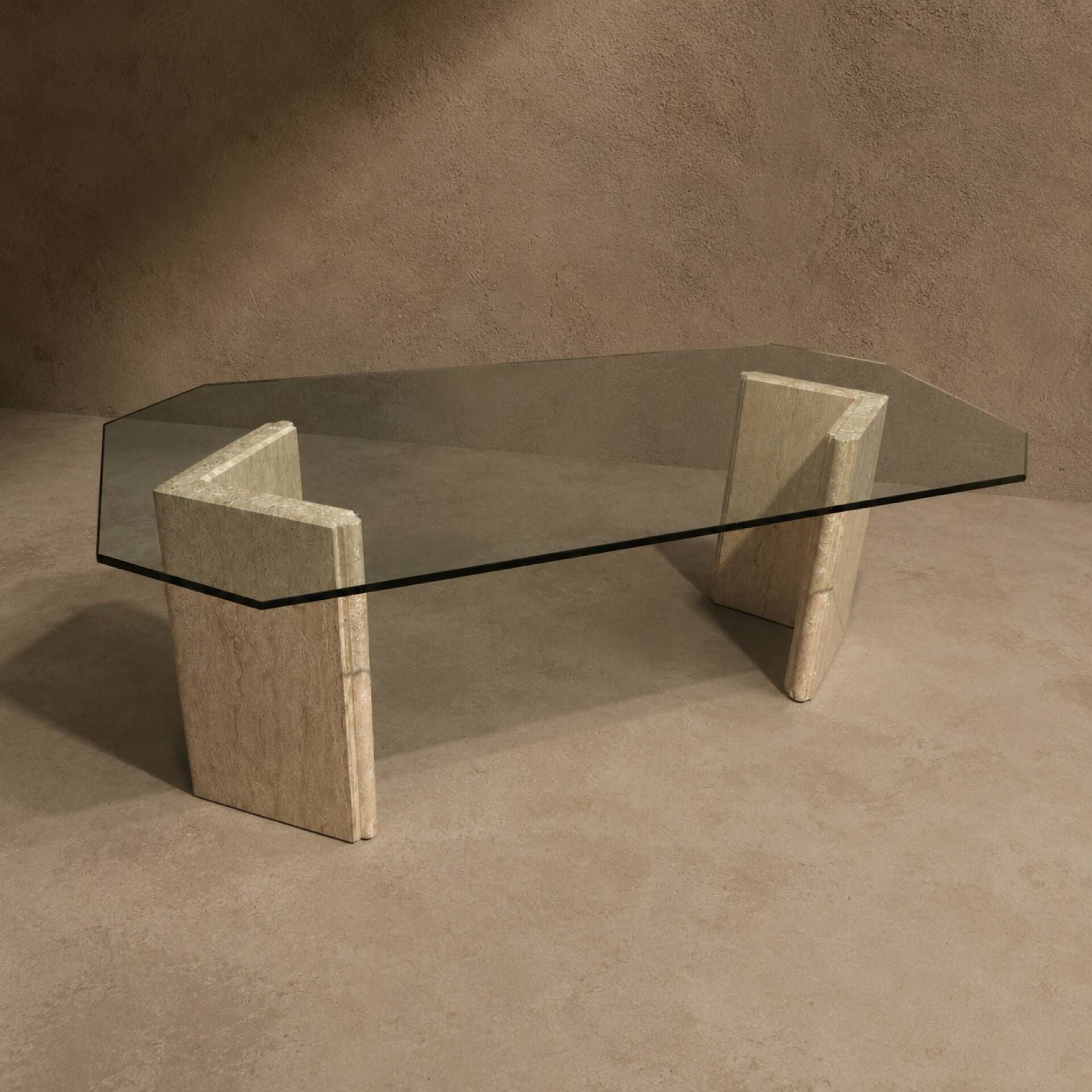 Dining table in travertine and smoked glass.