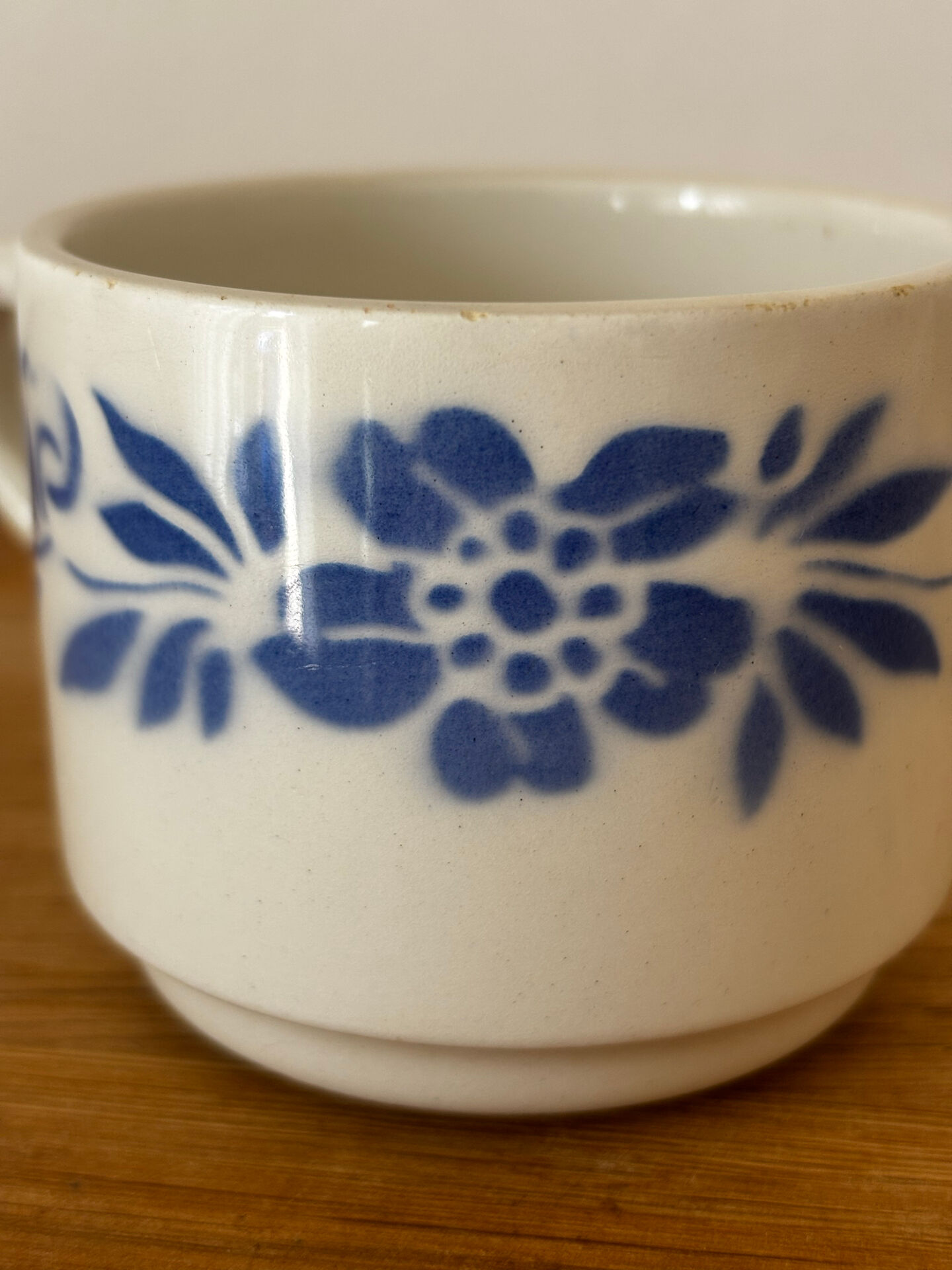 Set of 2 antique earthenware cups with blue floral pattern.
