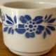 Set of 2 antique earthenware cups with blue floral pattern.