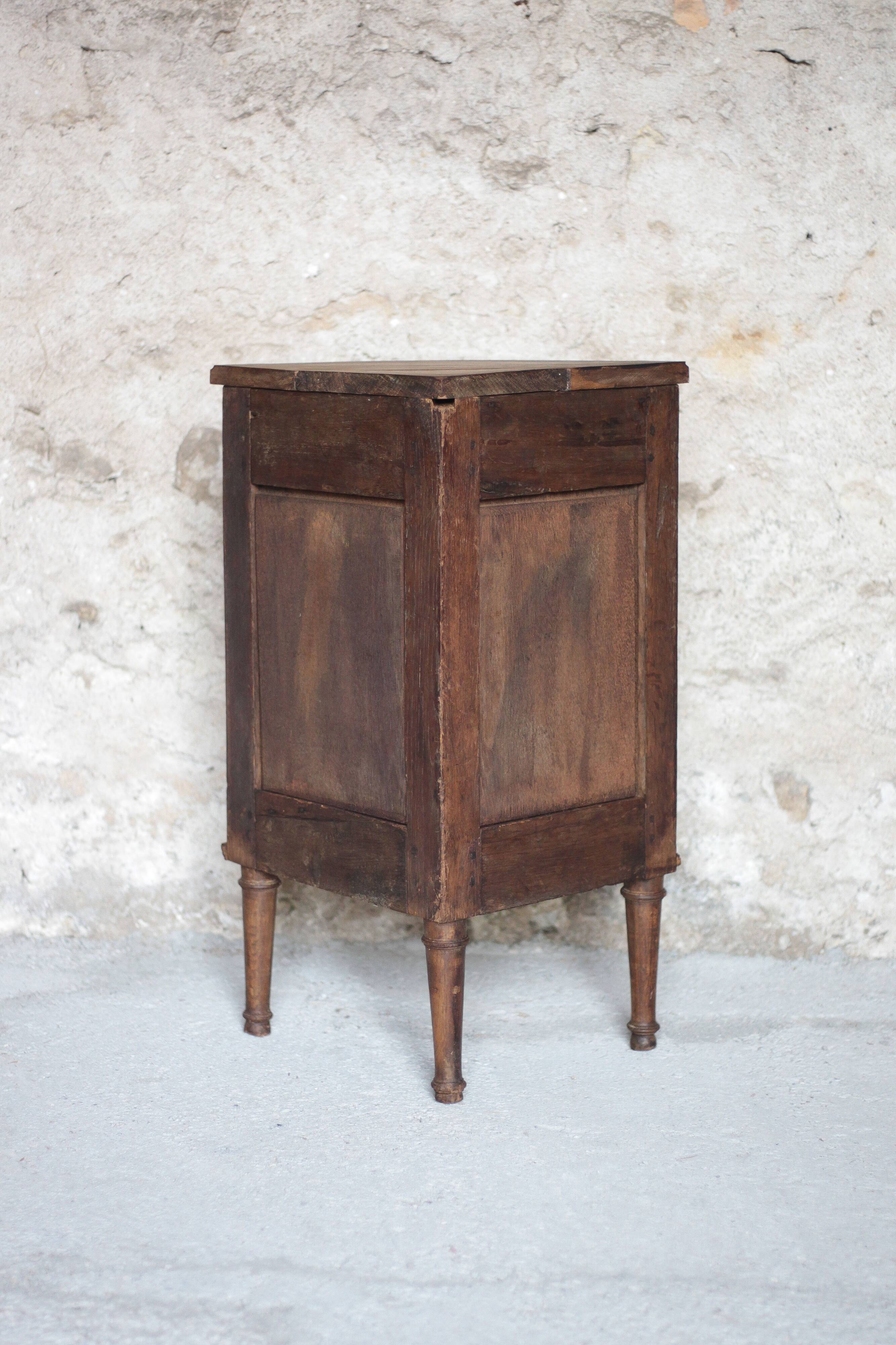 Antique wooden corner cabinet with a curved door.