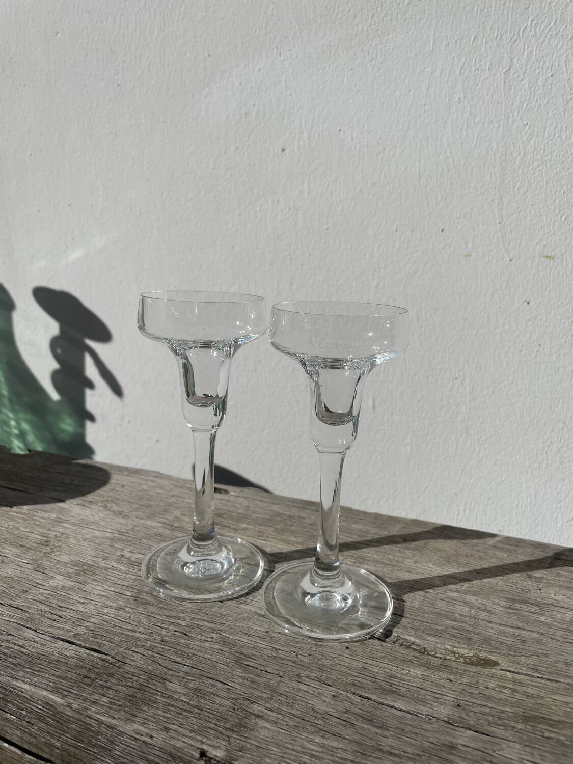 Pair of clear glass candlesticks, signed