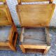 2 old wooden children's chairs with a small chest.