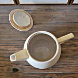 Vintage round ceramic teapot in cream colour, art deco style.