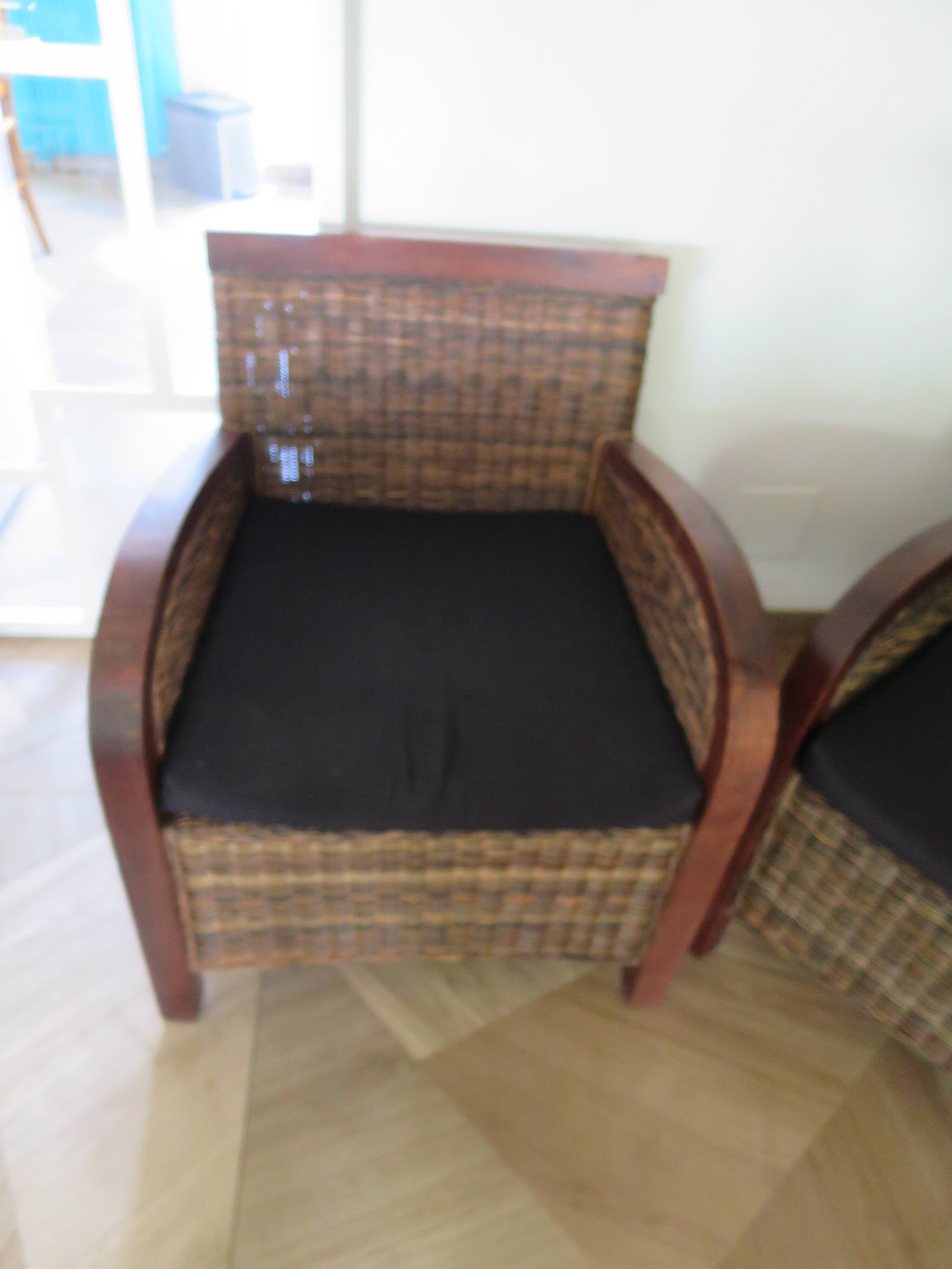 2 colonial-style armchairs in woven rattan and exotic wood