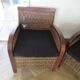 2 colonial-style armchairs in woven rattan and exotic wood